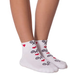 White ankle socks with a pattern of red hearts and black-and-white tennis rackets, shown on a person's feet against a white background. thumbnail