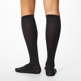 Woman wearing black Dr. Scholl's knee high socks thumbnail