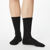 Woman wearing black Dr. Scholl's crew socks
