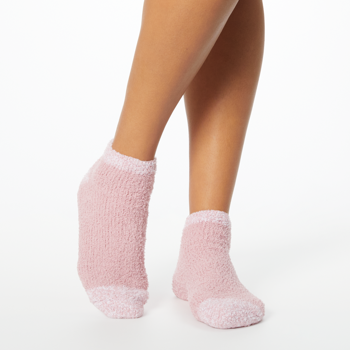 Person wearing pink two-toned tonal fuzzy Dr. Scholl's soothing spa socks.
