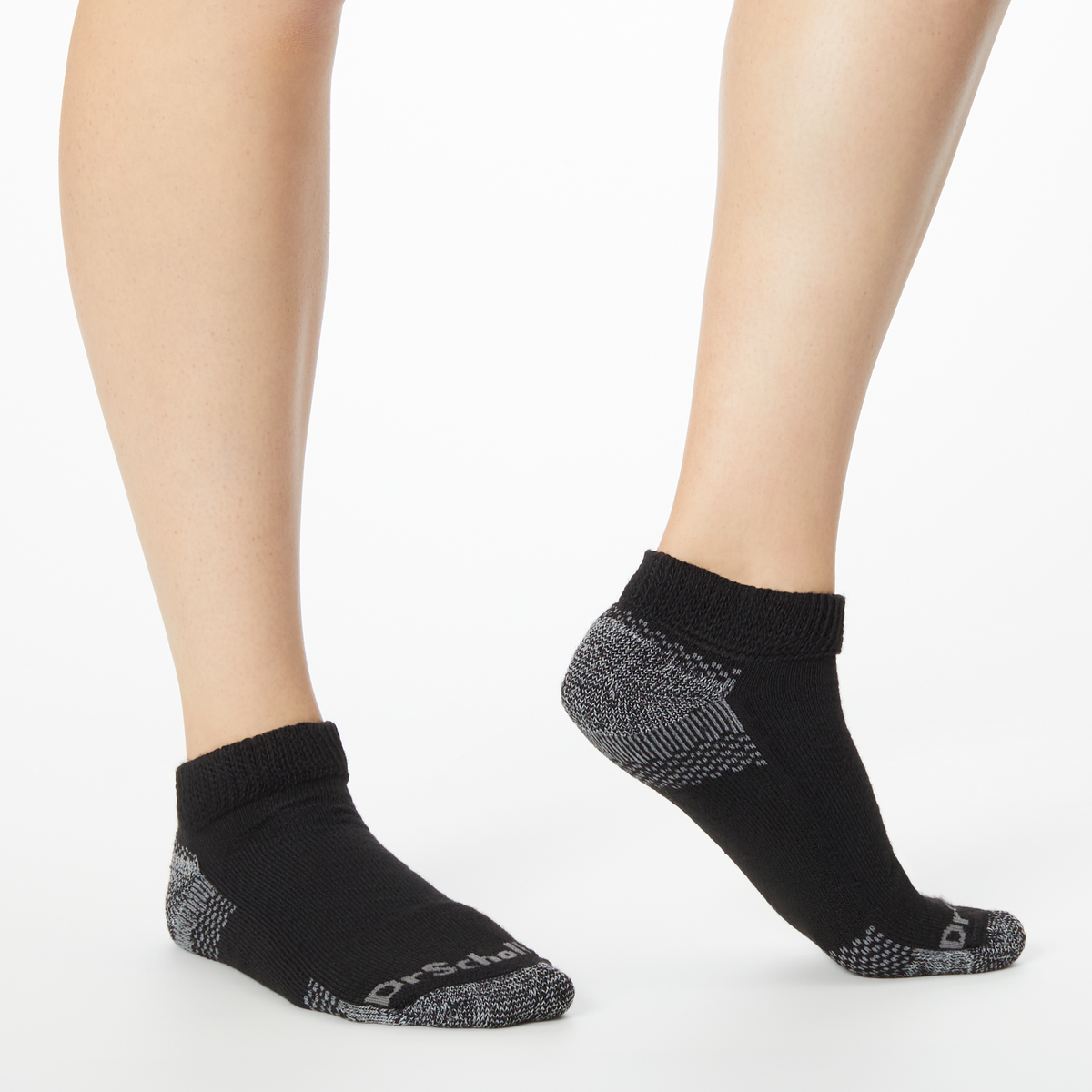 Person wearing black and gray Dr. Scholl's ankle socks.