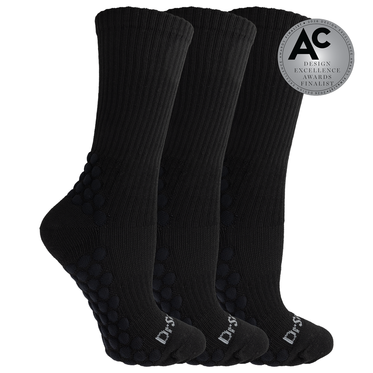 Three black crew socks with textured grip dots on the sole and heel, shown on a white background with a silver award badge overlay.