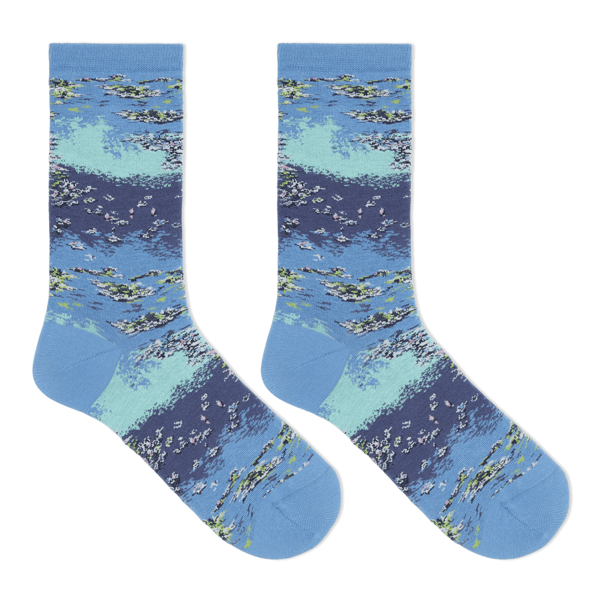 A pair of crew socks with a detailed watercolor-style print of a lake or river scene, featuring blue and light teal water, white ripples, and green reeds, displayed against a solid white background.