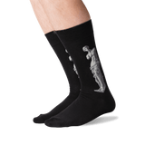Black crew socks worn on a person's legs, featuring a light gray classical statue graphic printed on the side.