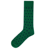 A single green crew sock with a repeating pattern of small dark navy blue polka dots, shown against a plain white background. thumbnail