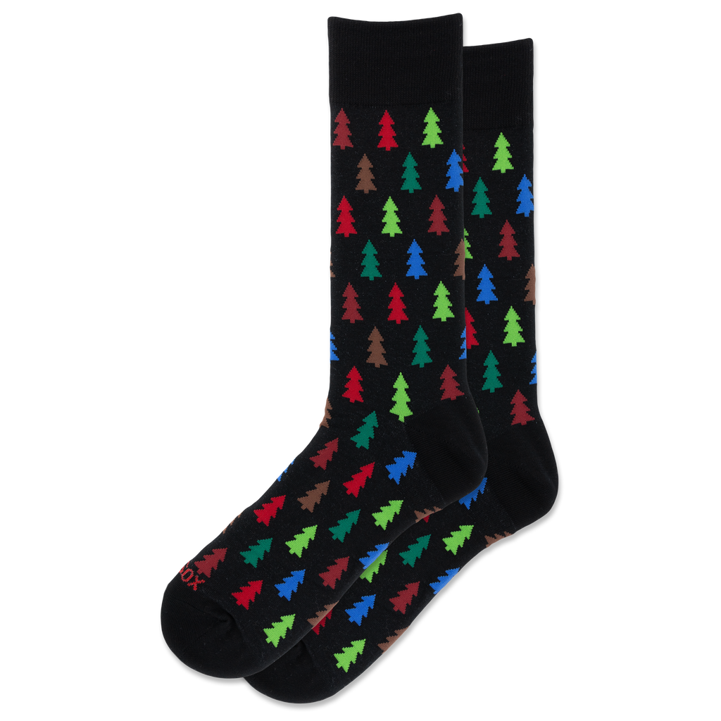 A pair of black crew socks with a repeating pattern of colorful Christmas tree silhouettes in red, green, blue, and brown, displayed against a solid white background.
