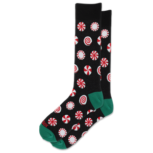 A pair of black crew socks with a red and white peppermint candy print and green toes and heels, displayed on a clean white background.