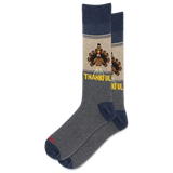 A pair of crew socks with a Thanksgiving theme. The socks feature a heather gray body, navy blue heels and toes, and a beige upper section with a cartoon turkey graphic and the word 'THANKFUL' in yellow.
