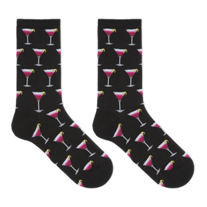 A pair of black crew socks with an all-over repeating pattern of pink and white cocktail glasses on a clean white background.