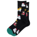 A pair of black crew socks with a repeating pattern of cute cats dressed in winter outfits, including Santa Claus and a reindeer, with a green toe cap and heel.