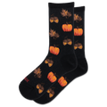 A pair of black crew socks with a repeating autumn pattern of orange pumpkins, acorns, and brown leaves, shown on a plain white background.