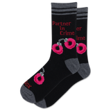 A pair of black crew socks with gray heels, toes, and cuffs, featuring pink and red graphic prints of handcuffs and the text 'Partner in Crime'.