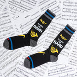 Two socks with musical design and text on a sheet music background thumbnail