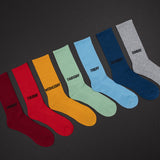 Set of colorful socks labeled with days of the week on a dark background