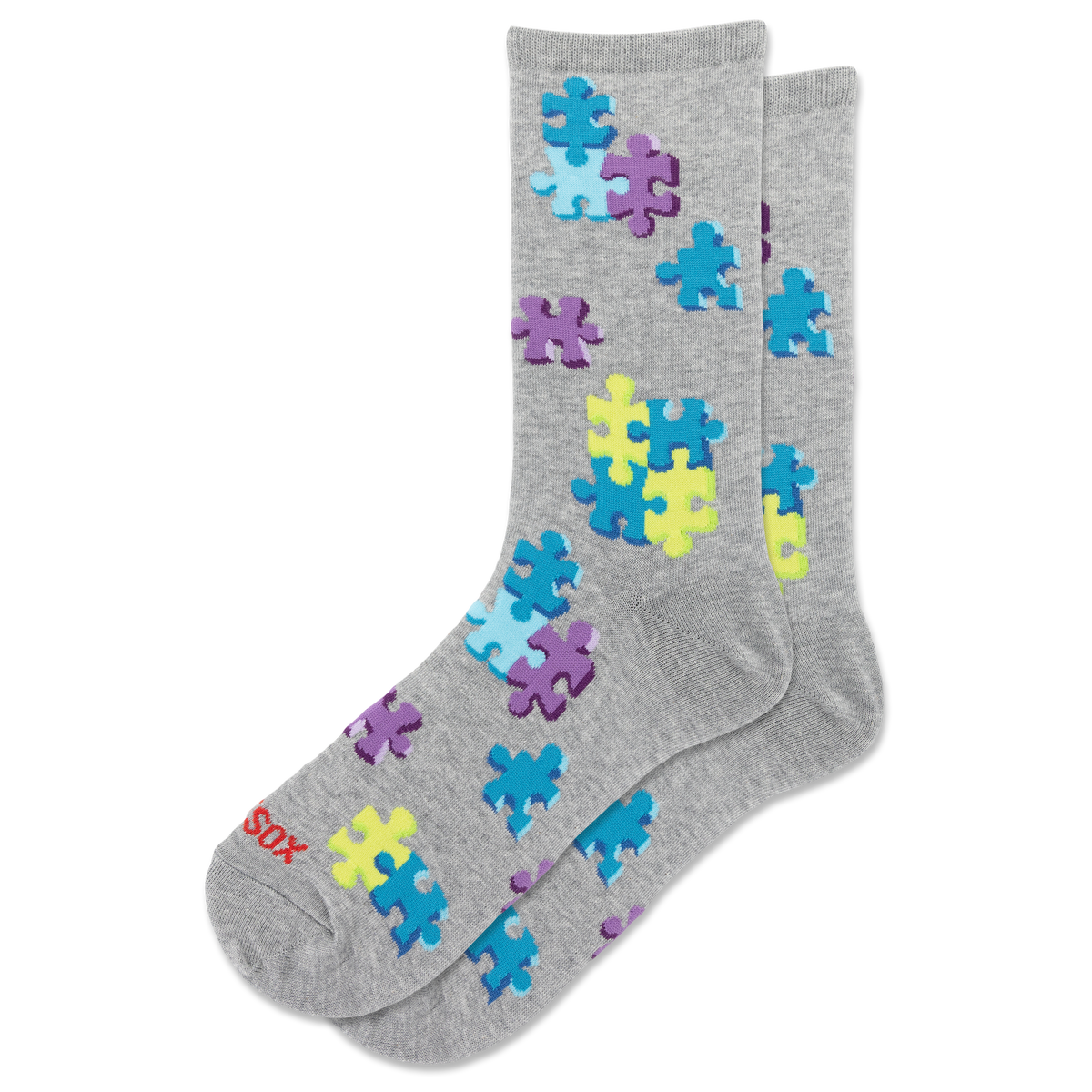 A pair of heather gray crew socks with a pattern of colorful puzzle pieces in blue, purple, and yellow. The brand name 'HOTSOX' is printed in red on the toe area.