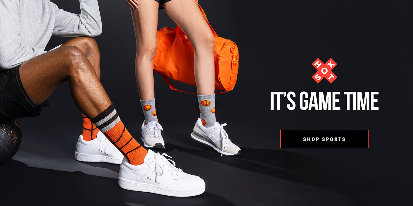 Two people wearing sports shoes and socks with an orange bag, promotional text 'It's Game Time' and 'Shop Sports' on a black background.