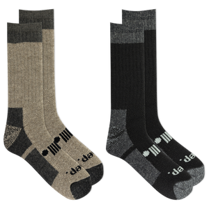 Two pairs of socks, one beige and black, the other black and gray, on a white background.
