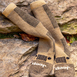 Pair of brown and beige socks with Jeep logo on a stone surface thumbnail