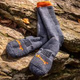 Gray socks with orange accents on a wooden surface thumbnail