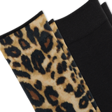 Close-up of folded knit socks, one with a leopard-print pattern in beige, brown, and black alongside a solid black sock on a white background.