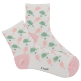 Pair of socks with a pattern of green and pink shapes on a white background, featuring the brand 'k.bell'. thumbnail