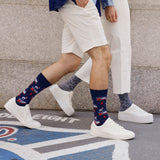 Two people wearing patterned socks and white sneakers on a street. thumbnail