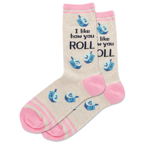 Beige socks with pink accents and blue dreidel designs, featuring text on a white background.