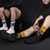 Two people wearing colorful socks against a black background thumbnail