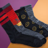 Four pairs of socks with different designs on a two-tone background