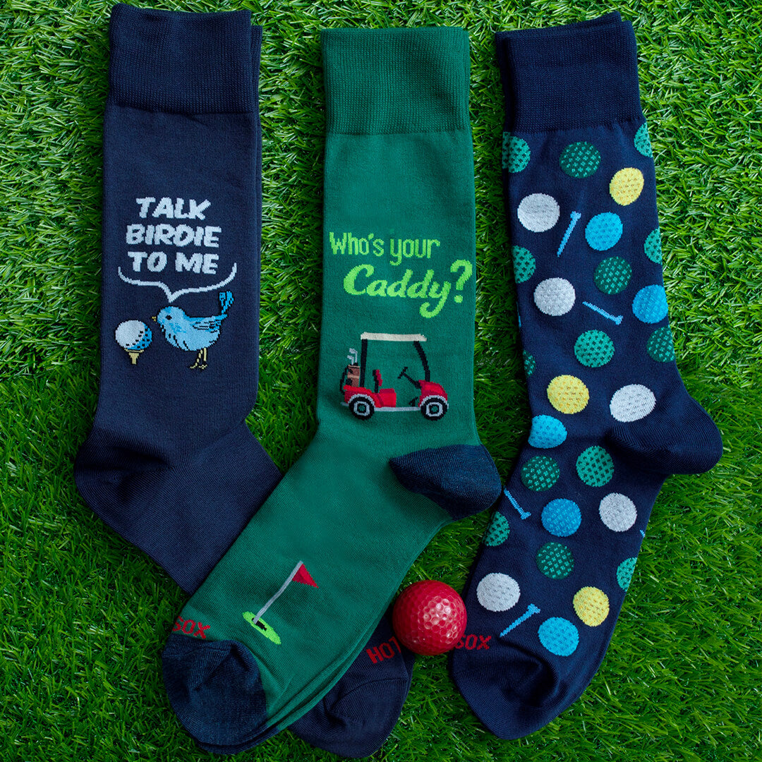 Thre pairs of HOTSOX men's golf-themed novelty socks.