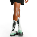 White socks with 'Iconic' text and green accents worn by a person on a white background thumbnail