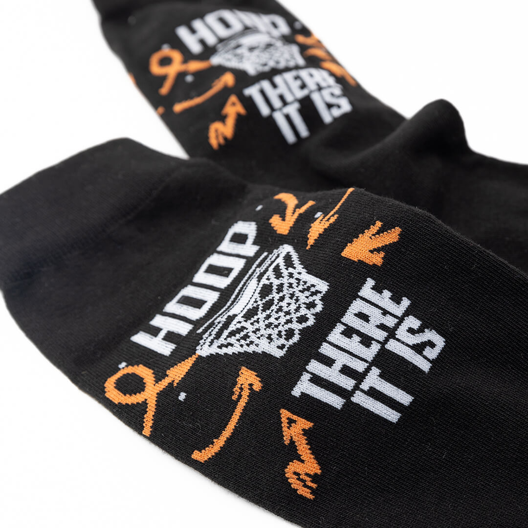 Black socks with graphic designs and text on a white background