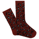 A pair of red boot crew socks with a leopard print pattern.