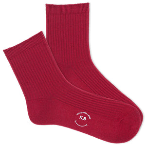 A pair of red ribbed ankle socks with the brand name 'K.Bell' displayed on the foot area.