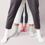 Three pairs of pants worn by different people on a plain background thumbnail