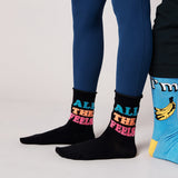 Black socks with colorful text and blue socks with banana design on a light gray background thumbnail