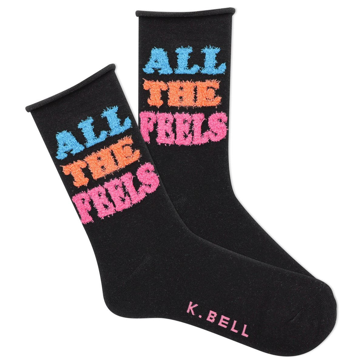 A pair of black fuzzy socks with the text 'All The Feels' in blue and pink colors, and the brand name 'K.Bell' at the end of the foot.