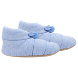 Pair of blue slippers with pom pom details on a white background