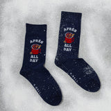 Navy socks with 'Apèrs All Day' text and graphic on a snowy background