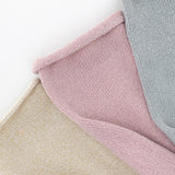 Close-up of textured pink, beige, and gray socks on a white background thumbnail