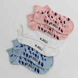 Set of K. Bell socks in pink, white, and blue with black pattern on a light gray background thumbnail