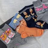 Collection of colorful socks with various designs and text on a textured surface