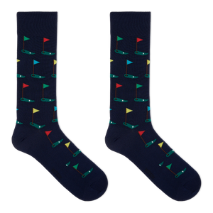 A pair of navy crew socks with a pattern of golf flags.